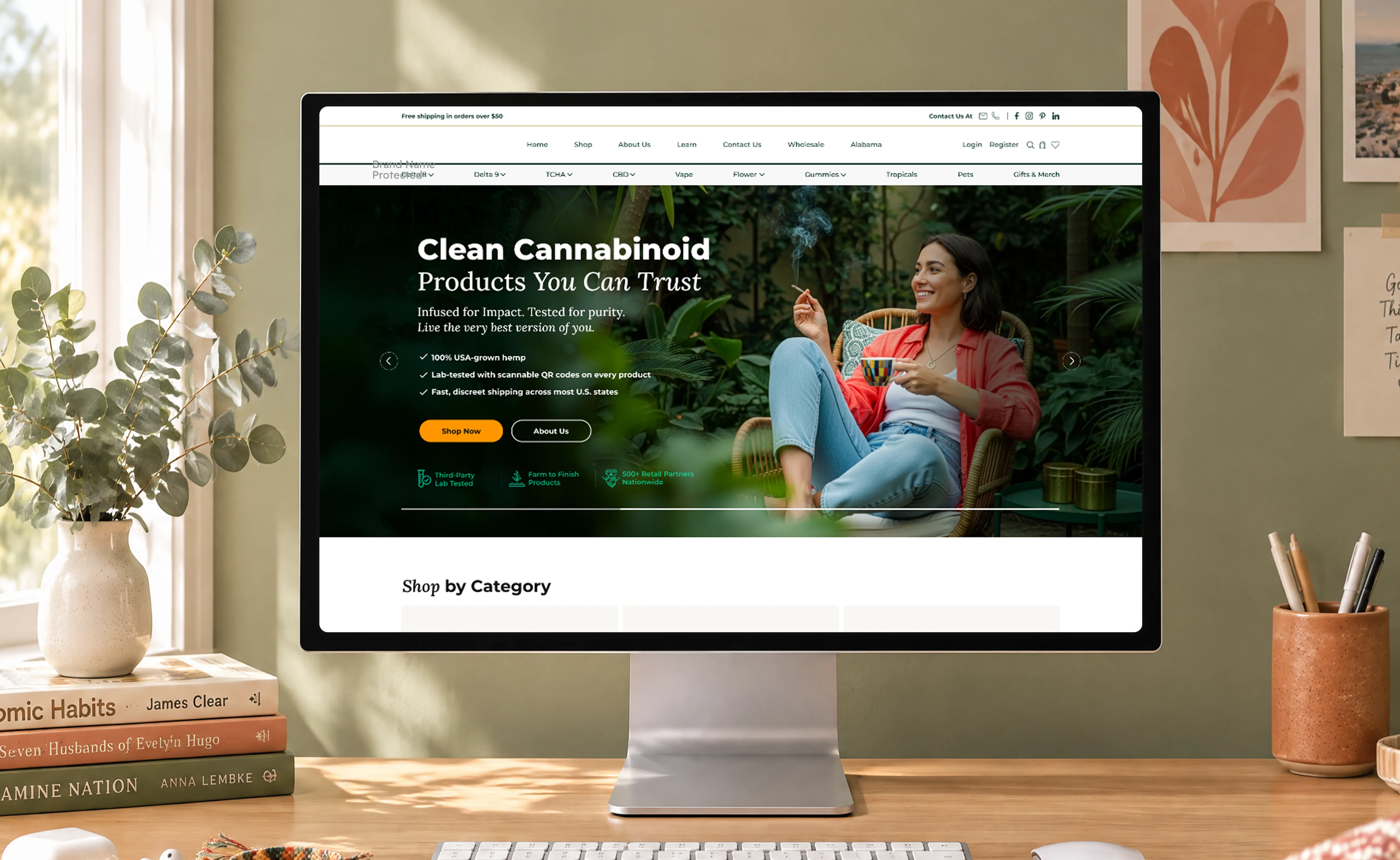 Pharma CBD home page design shown on a monitor on a desk, with the &ldquo;Clean Cannabinoid Products You Can Trust&rdquo; hero banner.